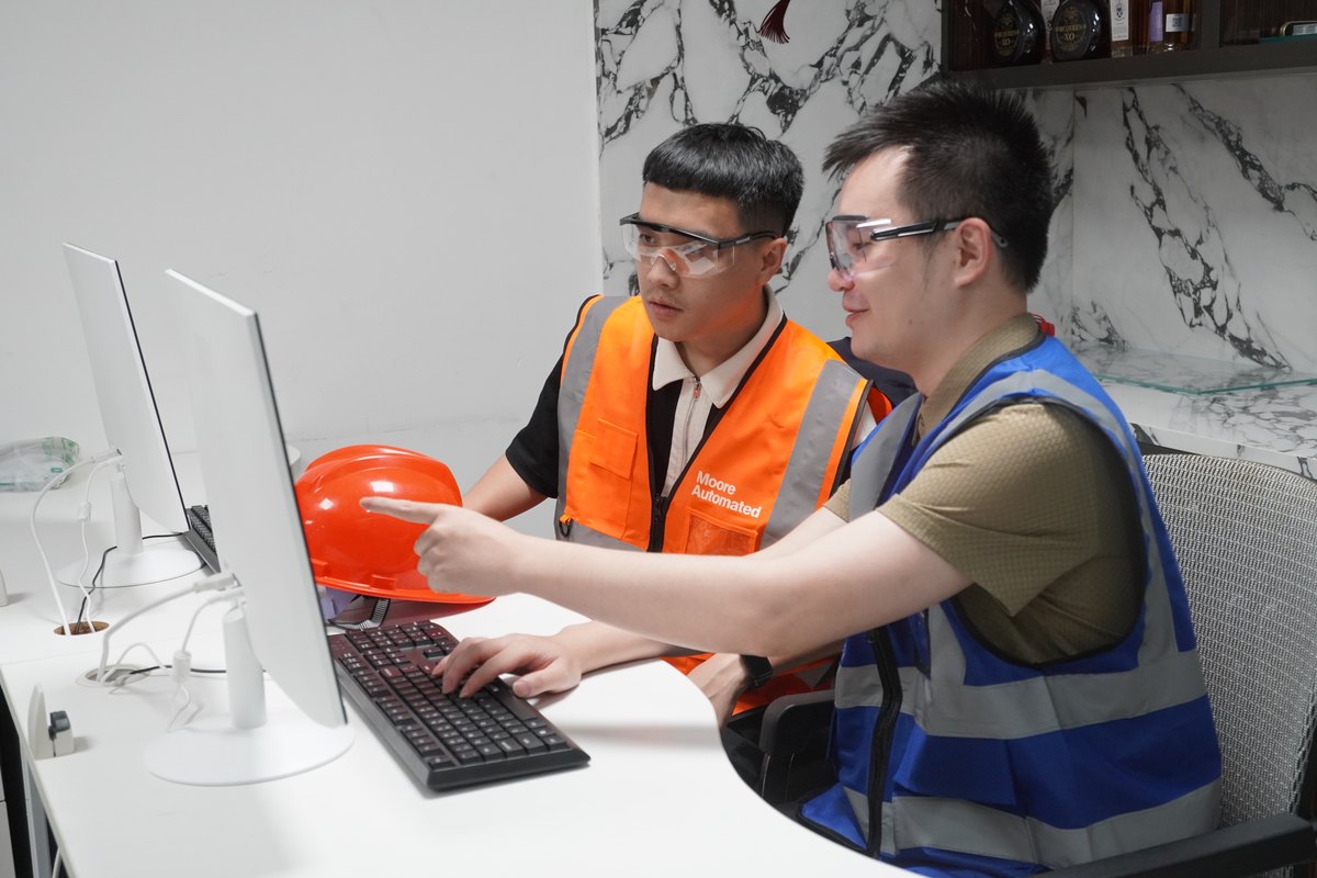 Apter Power team reviewing industrial automation project information