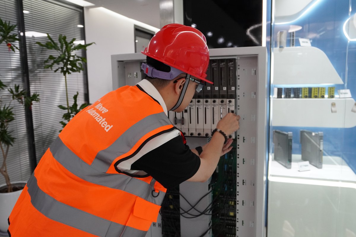 Apter Power engineer verifying industrial automation rack hardware